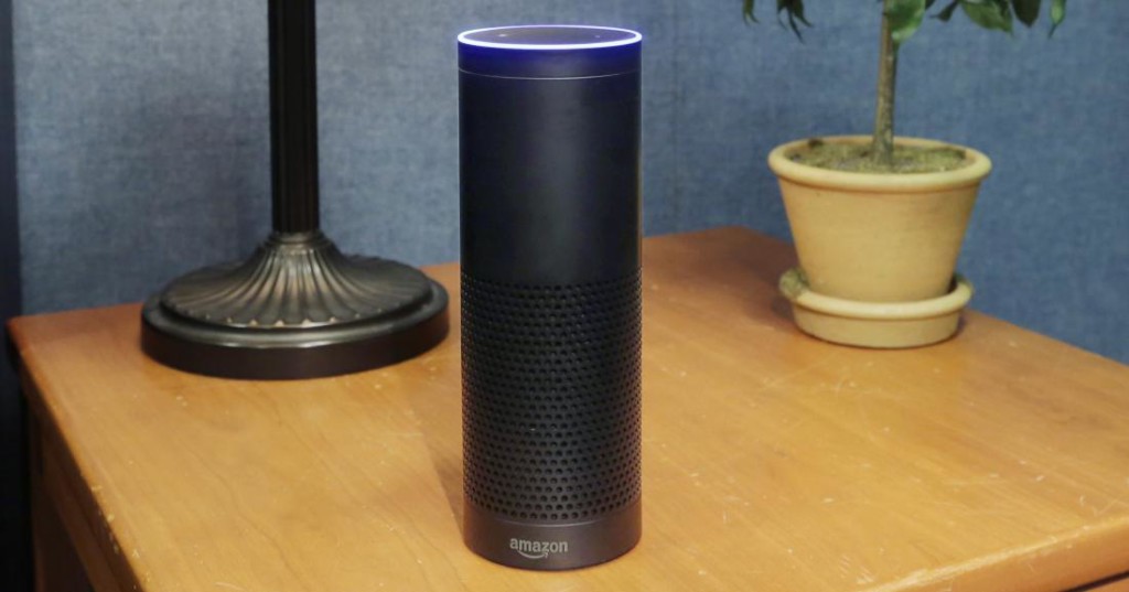 FILE - This July 29, 2015 file photo made in New York shows Amazon's Echo, a digital assistant that continually listens for commands such as for a song, a sports score or the weather. The company says Echo transmits nothing to Amazon’s data centers until you first say “Alexa” or press a button. A blue light also comes on to let you know it’s active. (AP Photo/Mark Lennihan, File)